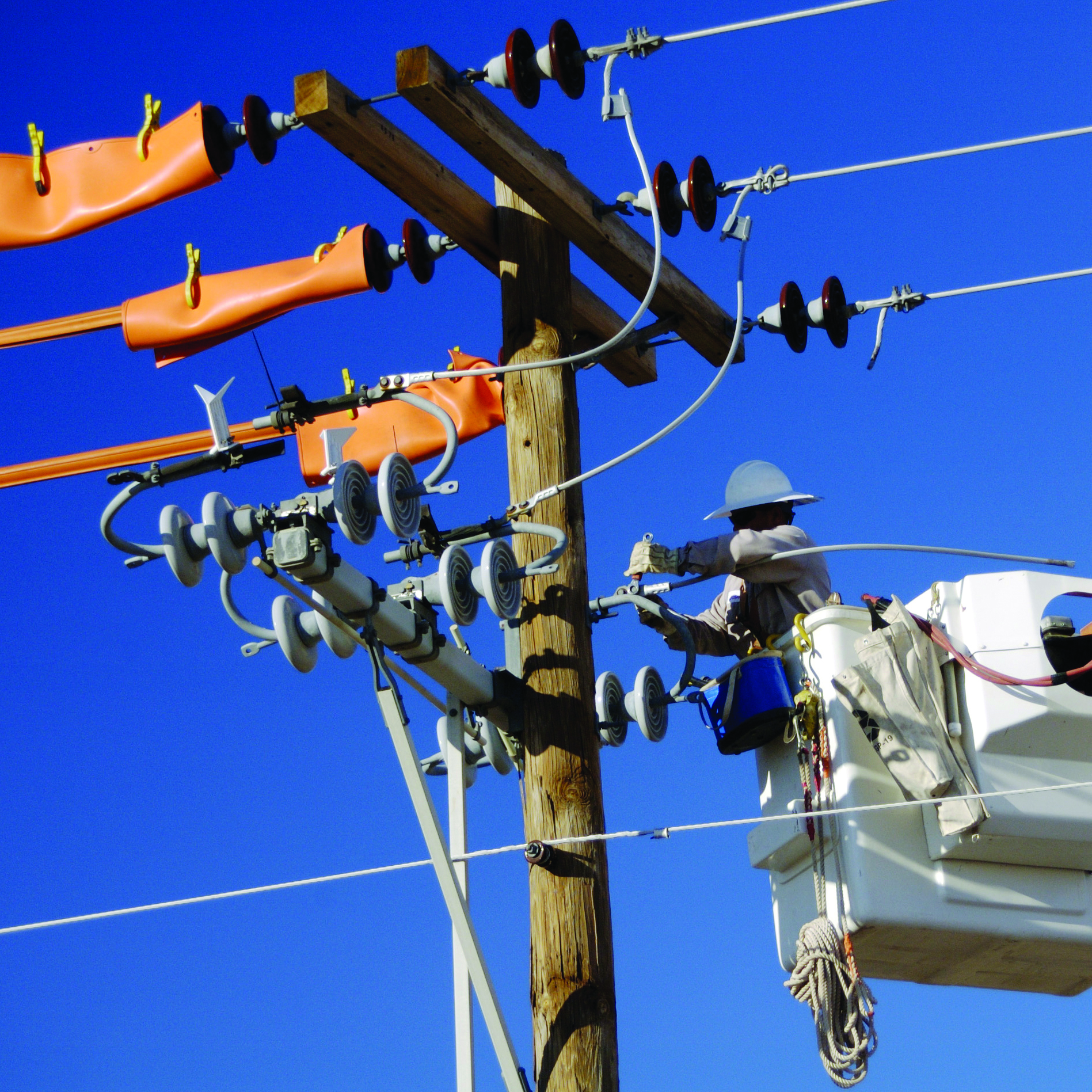 Electric utility lineman working on power lines.